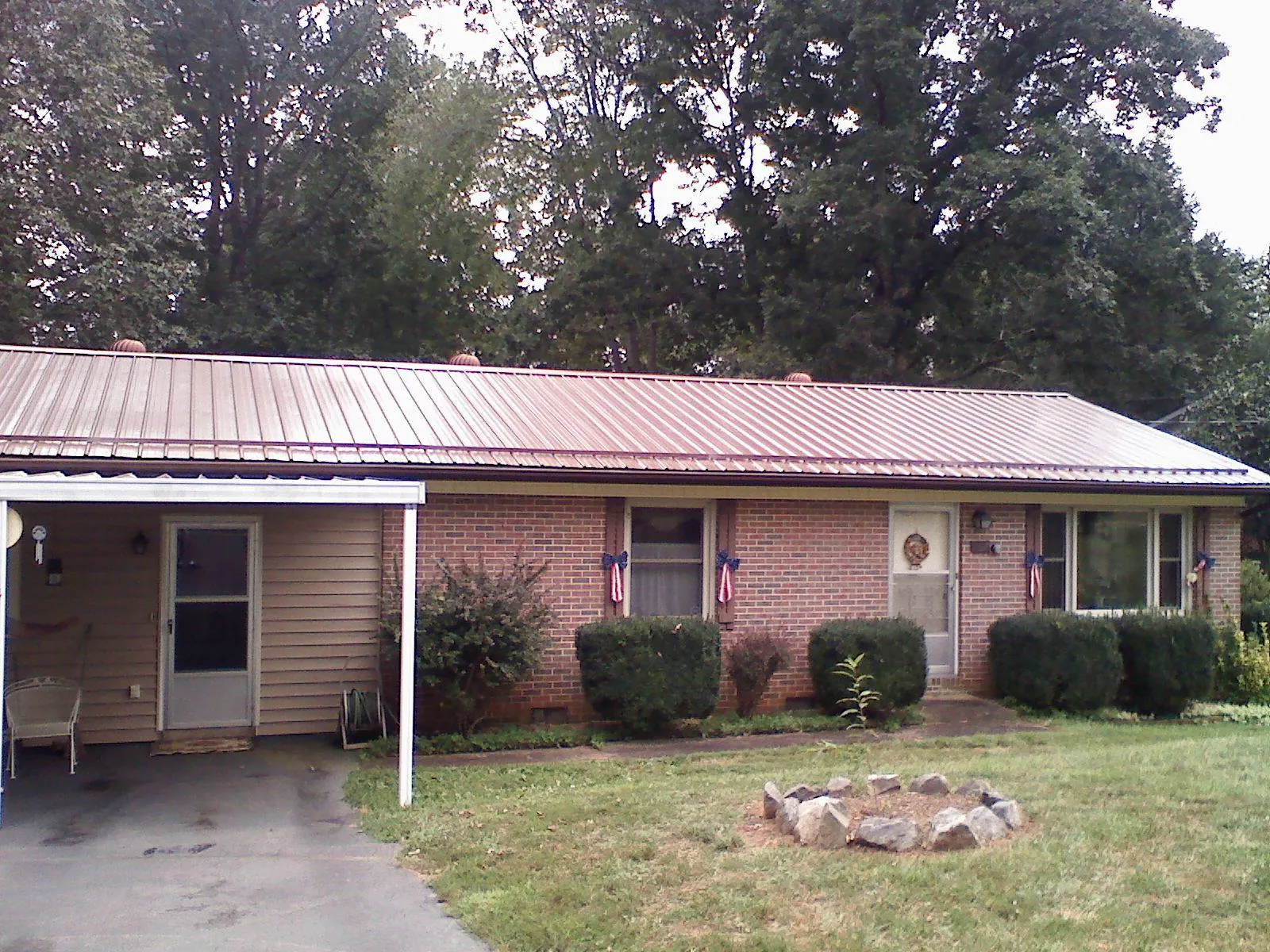 Bronze metal roof and carport on a brick ranch home — Roof Repair work by our crew in Old Greenwich