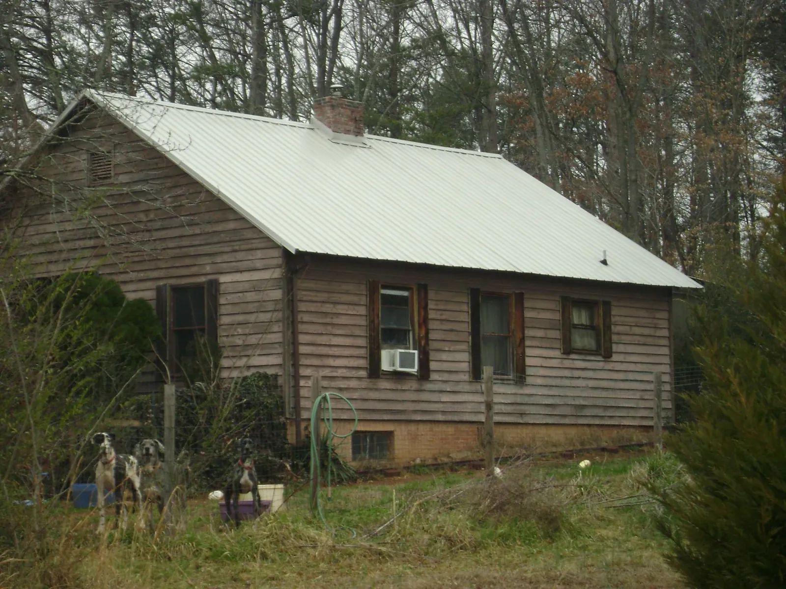 White metal roof on an old wood sided farmhouse, from a Metal Roof Installation job in Old Greenwich